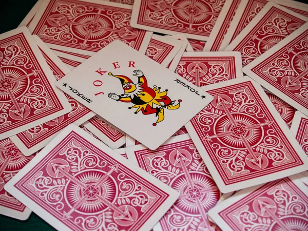 A deck of poker cards turned around and a joker card over