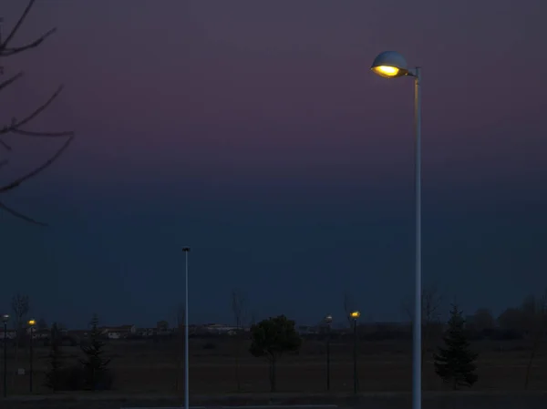 Street light on sunset on and urban landscape in Spain