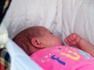 Yeni doğmuş bebek yatakta uyuyor. 