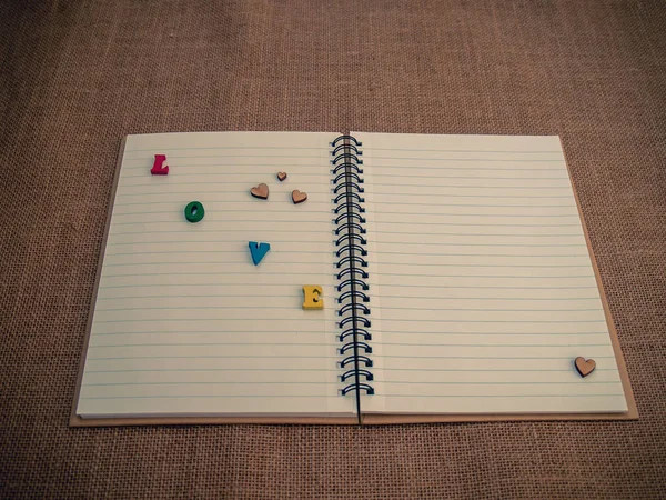 notepad with letters forming word love