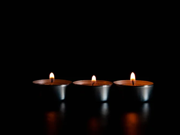 Three Lighted Candles Orange Flame Isolated Black Background — Stock Photo, Image