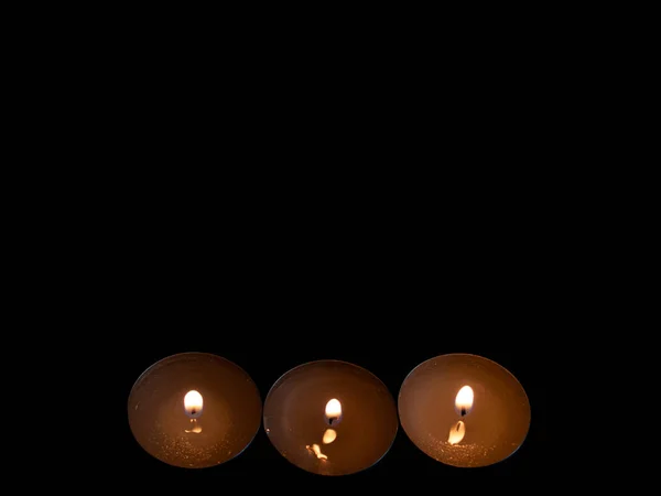 Tre Candele Accese Con Una Fiamma Arancione Isolate Fondo Nero — Foto Stock