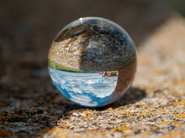 Reflections of clear sky in a crystal ball