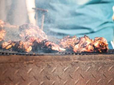 Tanınmayan kişi İspanya bir köyde popüler bir partide sokakta bir Barbekü domuz eti yemek