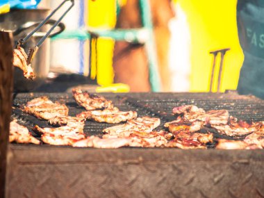 Tanınmayan kişi İspanya bir köyde popüler bir partide sokakta bir Barbekü domuz eti yemek