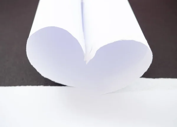 Розрив білого паперу у формі серця ізольовано в чорному — стокове фото