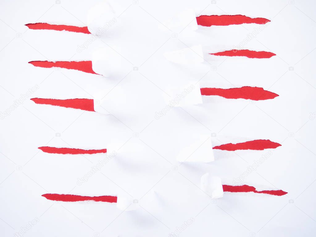 Torn white paper isolated on red