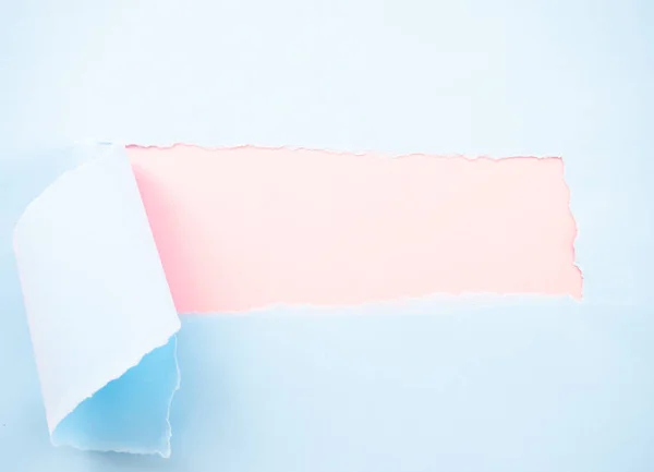 Torn pastel papel azul aislado en rosa pastel — Foto de Stock