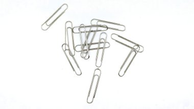 Beyaz arka planda izole edilmiş gümüş ataçlar, nesnelerin üst görüntüsü. rastgele konum