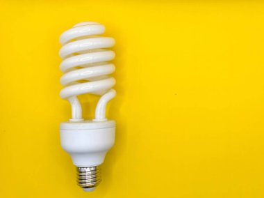 Sarı arkaplanda beyaz spiral ampulün üst görüntüsü. fikirleri tanımlamak için modern konsept