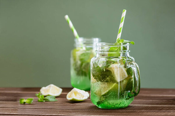 Drink of lime and mint in a glass on the table