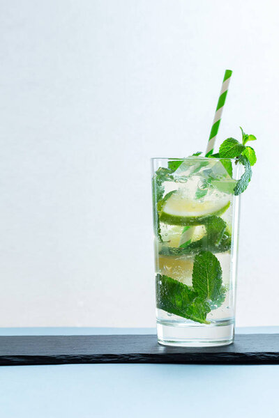 Drink of lime and mint in a glass on the table