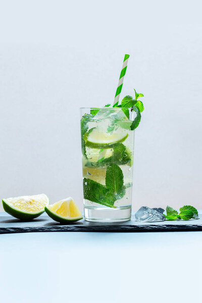 Drink of lime and mint in a glass on the table