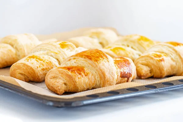 Fragrant and delicious French croissants on the kitchen table — Stock Photo, Image