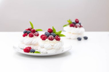 Ahududulu mini Pavlova tatlısı ve hintyağı şekerli yaban mersini.