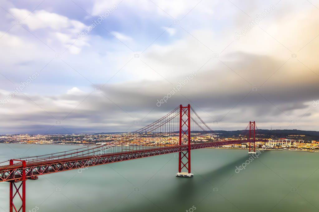 Long exposure photography of Lisbon and puente 25 de abril bridge in a cloudy day, Portugal