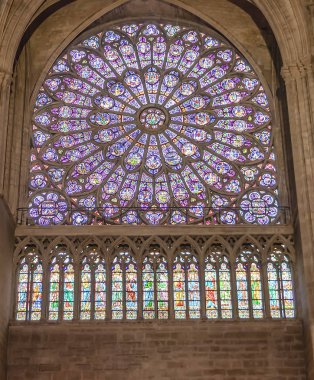 Paris, France - March 13, 2018: Stained glass window in Notre dame cathedral.  North Rose window at Notre Dame cathedral dates from 1250 and is also 12.9 meters in diameter. Its main theme is the Old Testament clipart