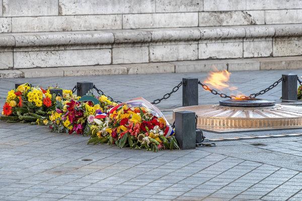 Flowers and fire under Arc de Triomphe in Paris, France
