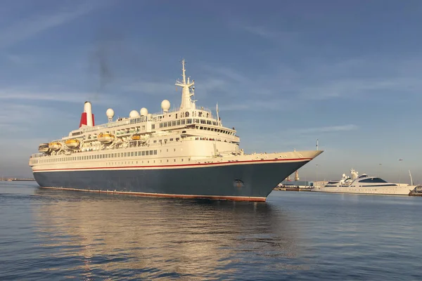 Cruise passenger ship in time of departure to the sea from Cadiz bay port at sunset