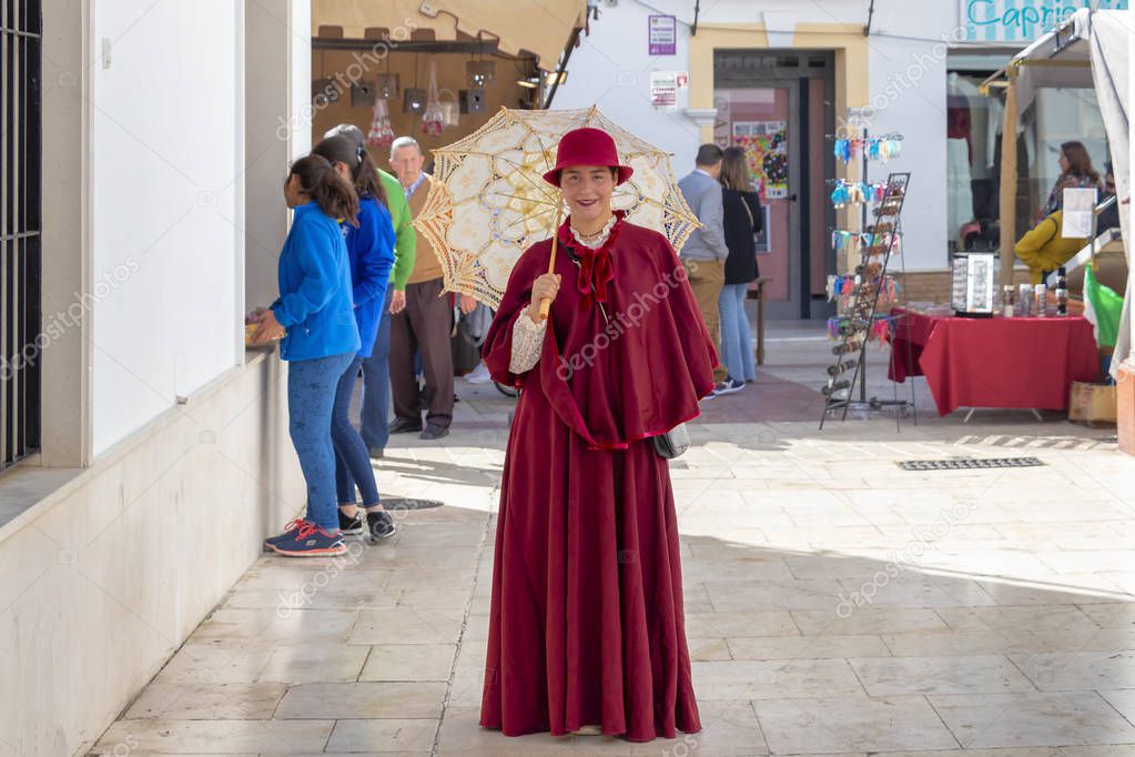 Moguer, Huelva, Spain - February 24, 2019: Girl dressed in old f