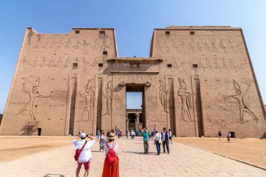 Aswan, Egypt - September 13, 2018: Tourists visiting the Edfu Te clipart