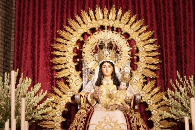 Huelva, Spain - August 15, 2020: The Virgin of Clarines on the main altar of the Parish of San Bartolome Apostol in Beas, Huelva, Andalusia, Spain clipart