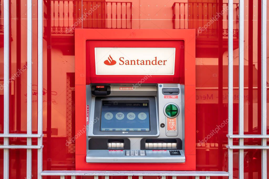 Huelva, Spain - August 16, 2020: ATM machine of Bank Santander  in the town of Valverde del Camino, Huelva, Spain. It is largest bank in the eurozone and one of the largest in the world