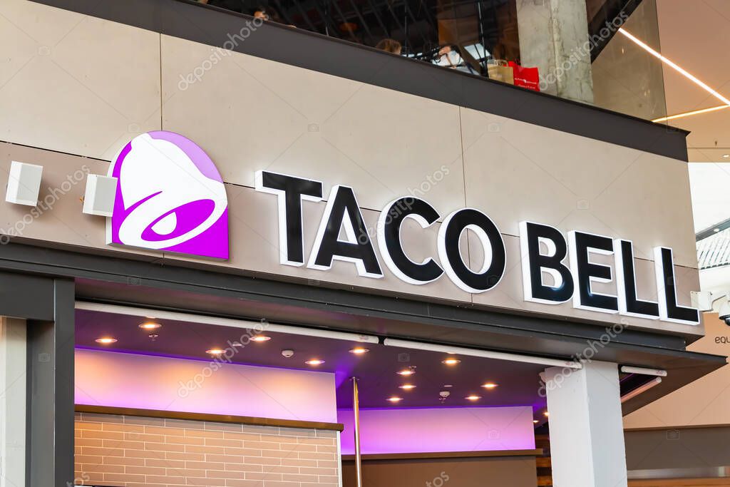 Seville,Spain - September 18,2020: Taco Bell, a fast-food restaurant of Mexican inspired menu, tacos, burritos, quesadillas, nachos,serves more than 2 billion customers each year at 7,072 restaurants