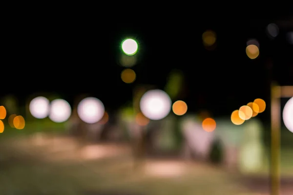 Night twilight blurred light gold bokeh reflecting on the sea surface water abstract background.