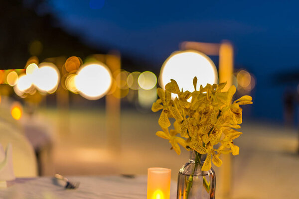 Night twilight blurred light gold bokeh reflecting on the sea surface water abstract background.