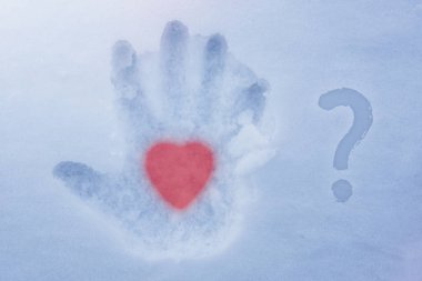 A hot heart in a cold hand and a question mark. Love theme clipart
