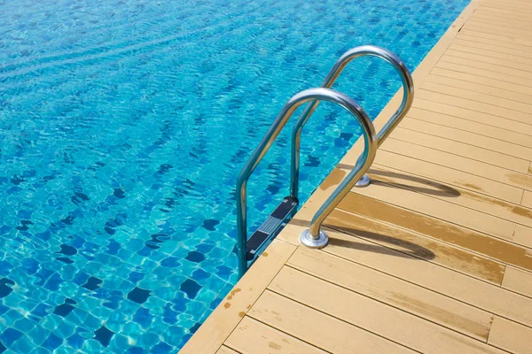 Metal pool ladder. Swimming pool on the roof after the rain. Swimming pool detail