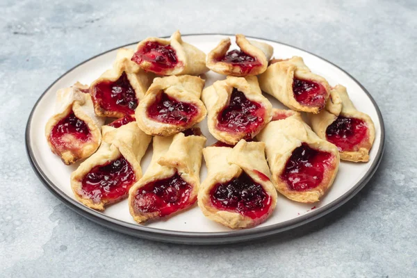 Homemade cookies with jam on a plate. Wooden background