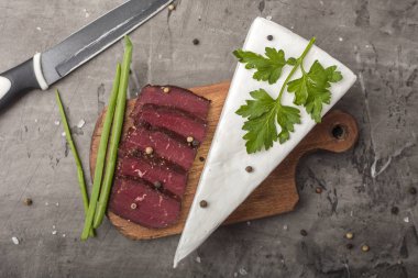 Bir ahşap, kesme tahtası ve yeşil soğan kurutulmuş et. Beyaz kalıp ile yumuşak peynir 