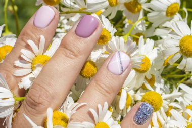 Papatya çiçek güneşli bir arka plan üzerinde güzel kadın manikür