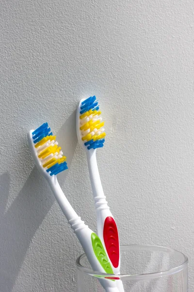 Two New Toothbrushes Glass Light Background Copy Space — Stock Photo, Image