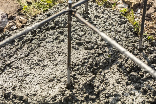 Wet cement during the pouring of concrete foundation. Foundation of the house