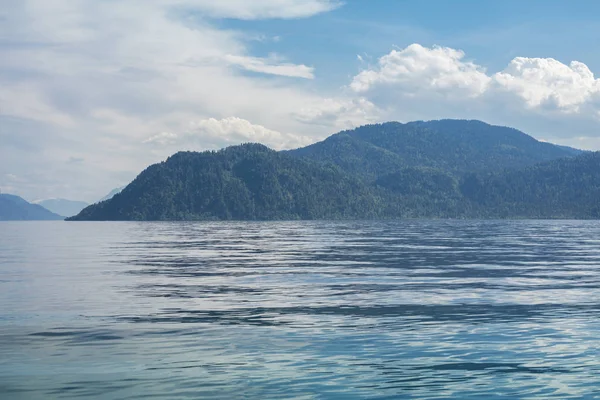 Beautiful Mountains of Altai in the blue haze on Lake Teletskoye