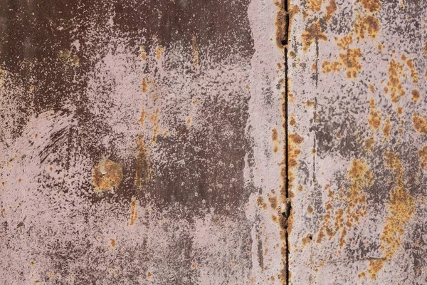 Old rusty and scratched surface of iron in pink paint - grunge texture