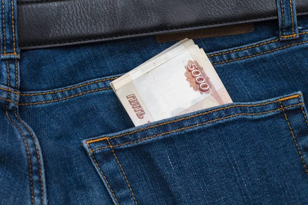 Russian money in the pocket of jeans. Banknote 5000 rubles. The concept of finance. Close-up. Copy space