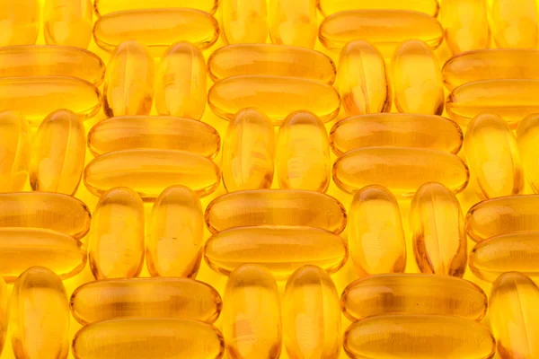 Ómega Cápsulas Óleo Peixe Sobre Fundo Amarelo Textura Padrão — Fotografia de Stock