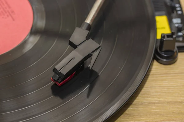 Vinyl player with copy space. Needle on rotating black vinyl plate. Included gramophone and rotating plate. Stylus with a close-up of a needle