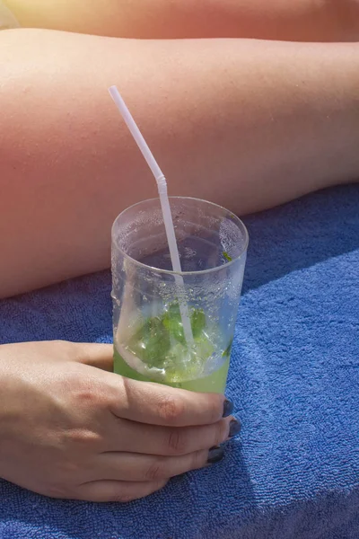 Woman Holding Glass Mojito Ice Her Hand Resting Blue Towel — Stock Photo, Image