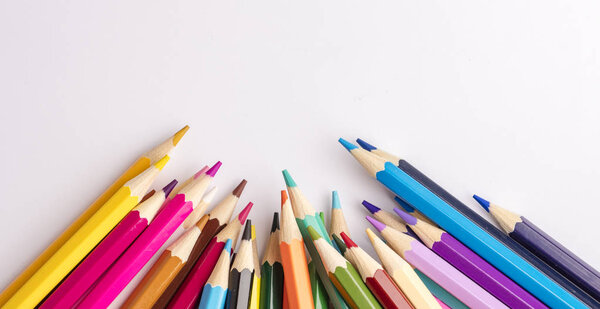 Color pencils on a light background. View from above. Copy space  