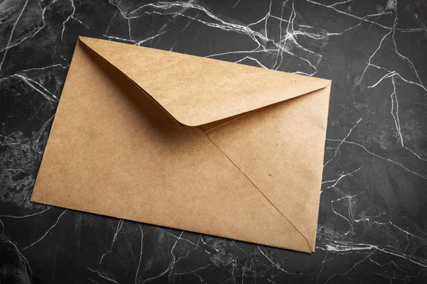 craft paper envelope on black background. Mock-up