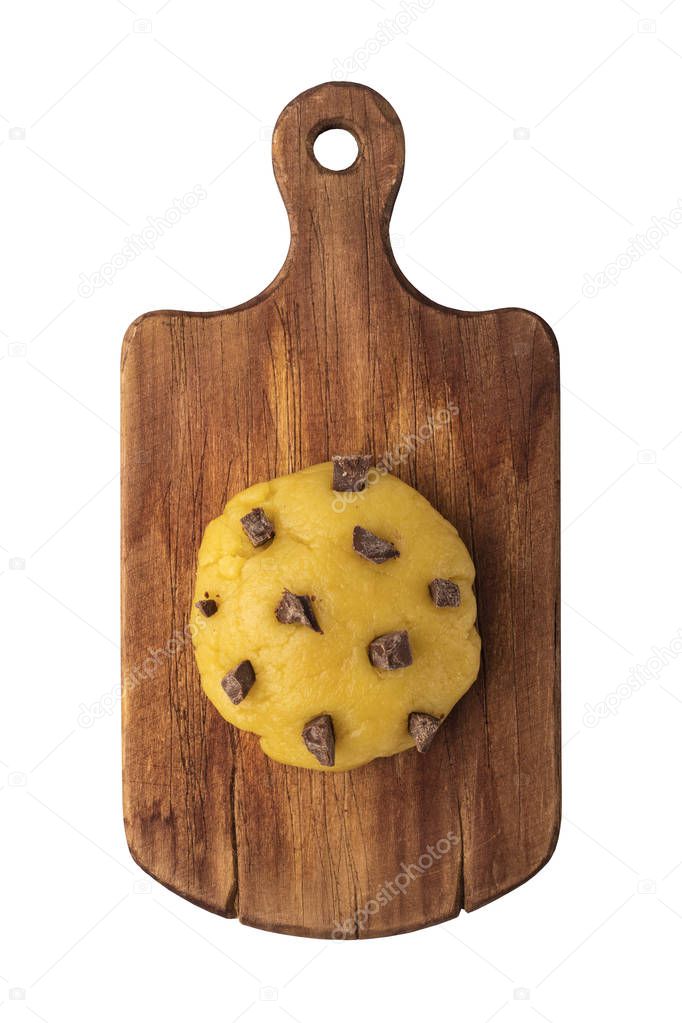Raw cookie dough with chocolate chips on a cutting board, top view. Isolated object