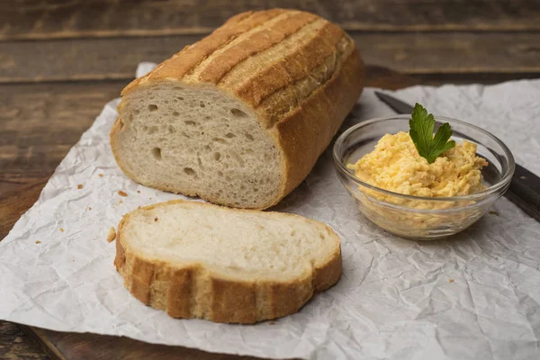 White bread. Sandwiches with grated cheese. Wooden background