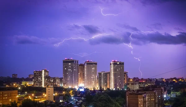 Beautiful lightning in the sky at the city at night. Lightning strikes in the dark sky