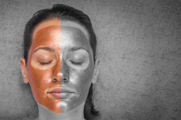 Beautiful woman with a cleansing bronze and silver mask on her face. Concept of skin care and spa. Closeup. Copy space