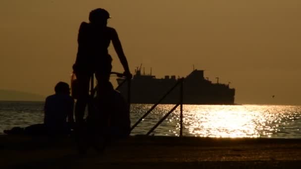 Split Chorwacja Października 2017 Sylwetka Rowerzysty Dwóch Mężczyzn Siedzących Plaży — Wideo stockowe